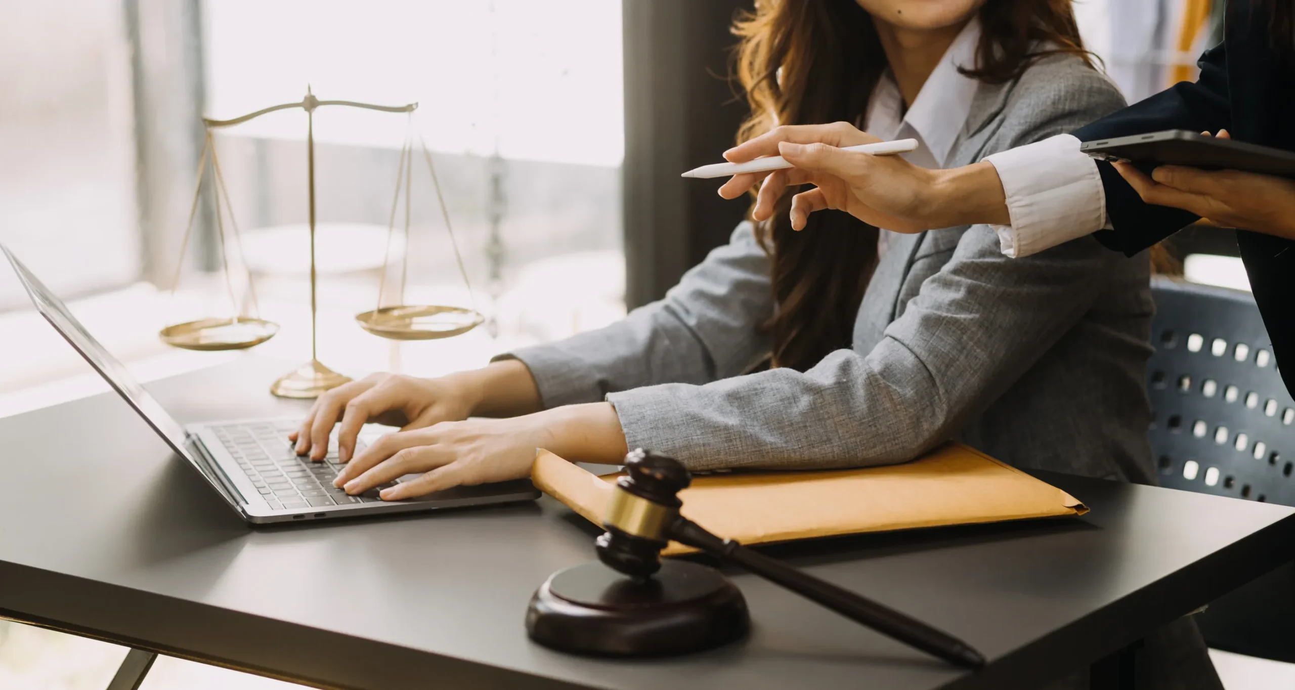 Male lawyer working with contract papers and wooden gavel on tabel in courtroom